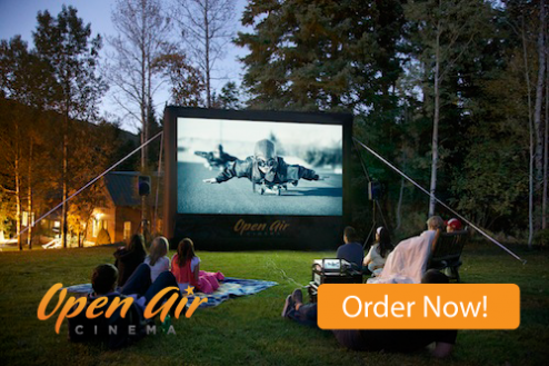 Families watching outdoor movies on an Open Air Cinema inflatable screen