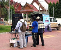 Technicians set up the equipment for the outdoor movie screening.