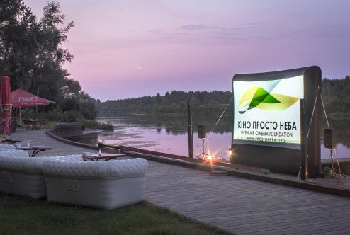 enjoy a good movie by the river during the warm summer sunset