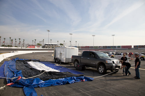Crowd gathering for a Days of Thunder outdoor screening at the speedway