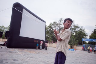 Open Air Cinema Standard 20' inflatable movie screen at a large outdoor event